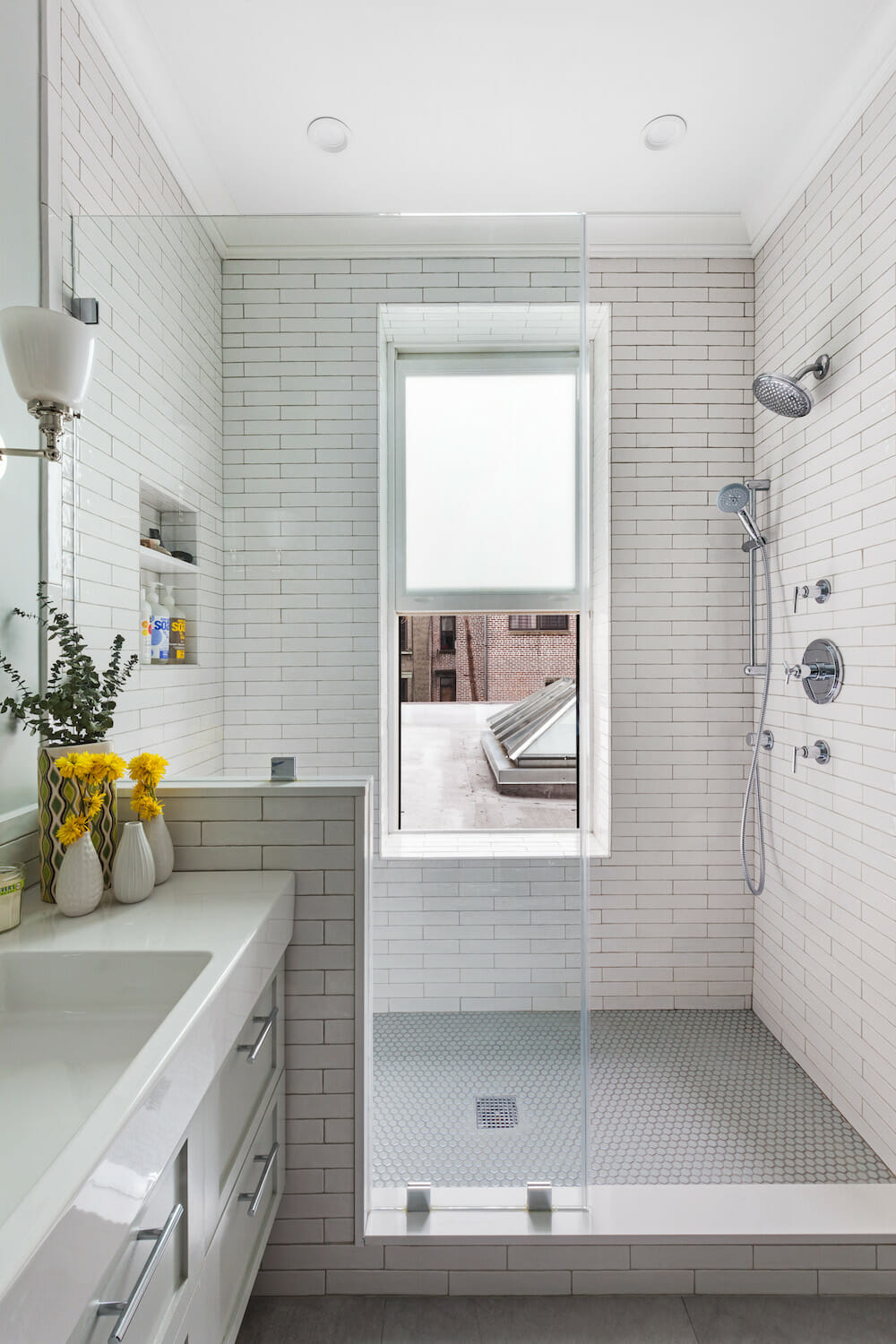 Image of a white bathroom with subway tile and walk-in shower