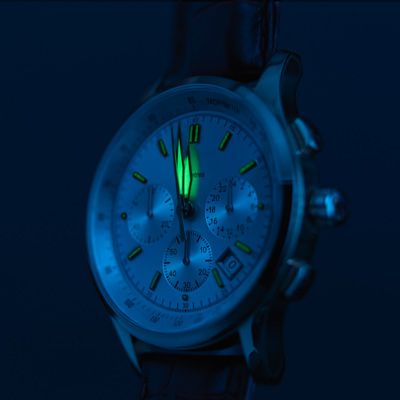 A wrist watch with a glowing minute hand.
