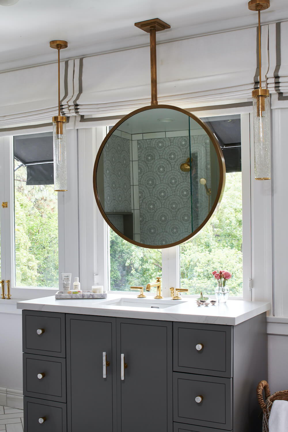 Bathroom with modern bronze hanging vanity mirror