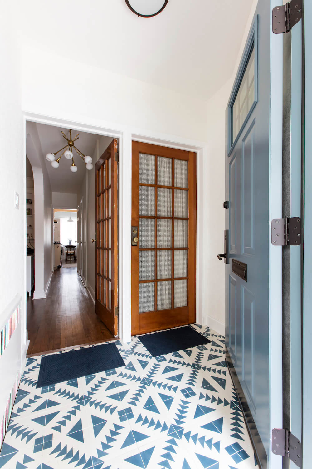 Image of a renovated entryway with blue and white floor tile