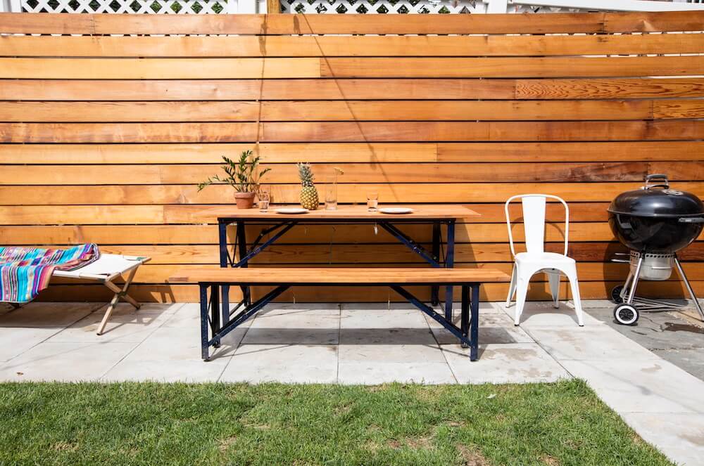 Image of a backyard with new cedarwood walls and picnic table