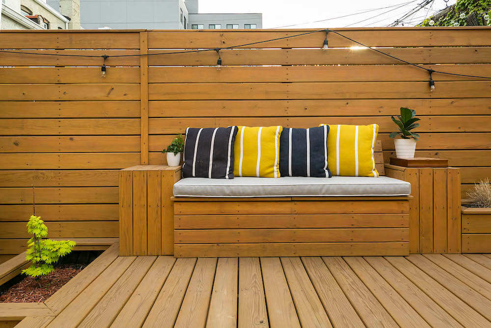 Image of a remodeled backyard with built-in bench seat