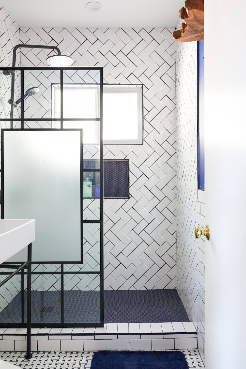 Image of a gut remodel bathroom with walk-in shower and herringbone shower