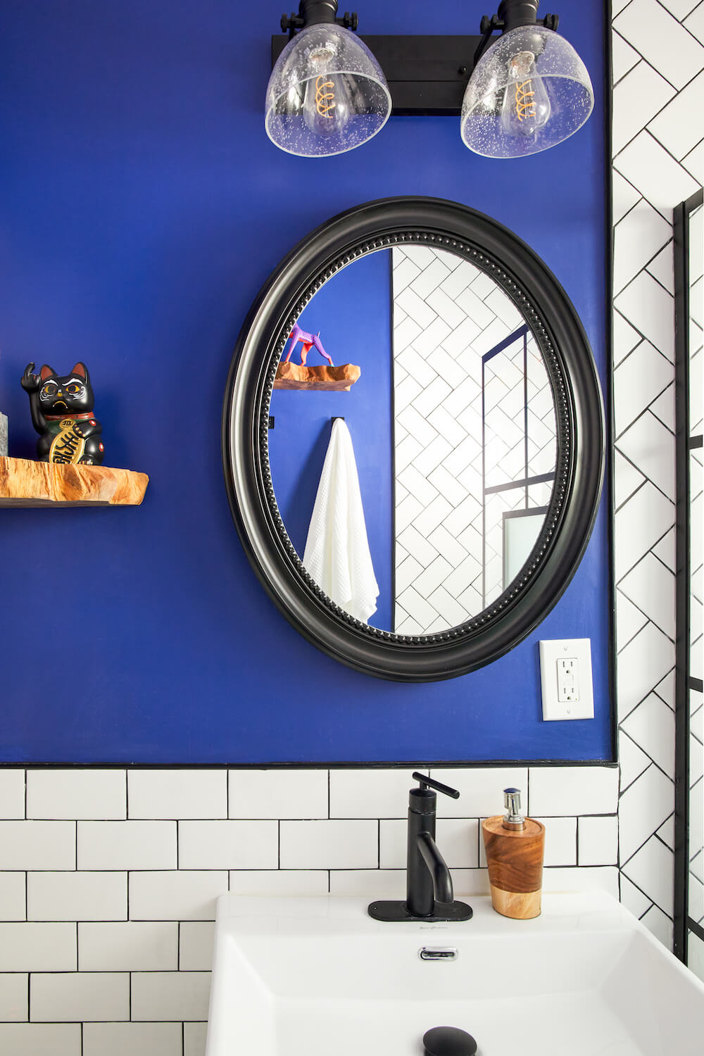 Image of a blue bathroom accent wall with sink and mirror