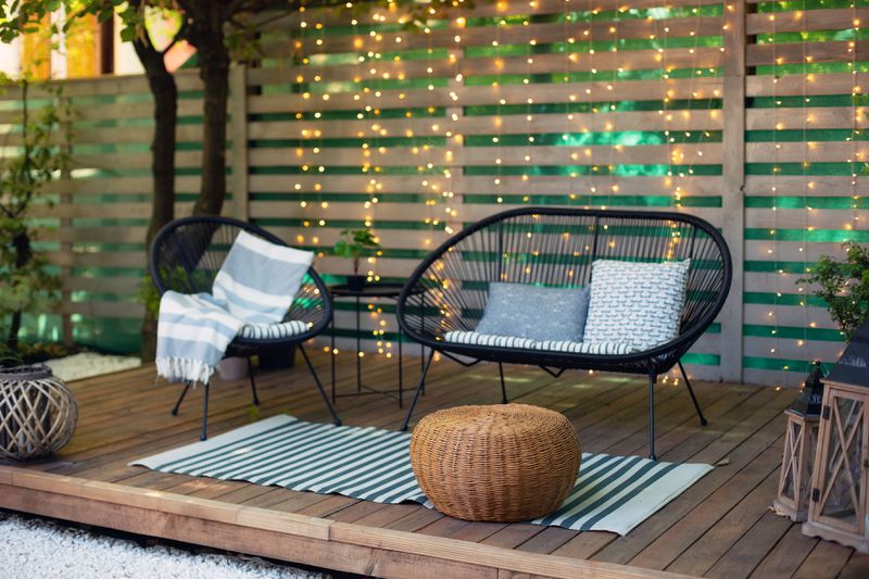 An outdoor sitting area with curtain lights.