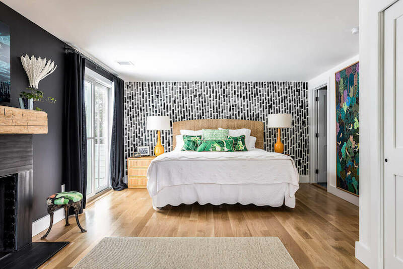 master bedroom with black and white painted mural behind bed