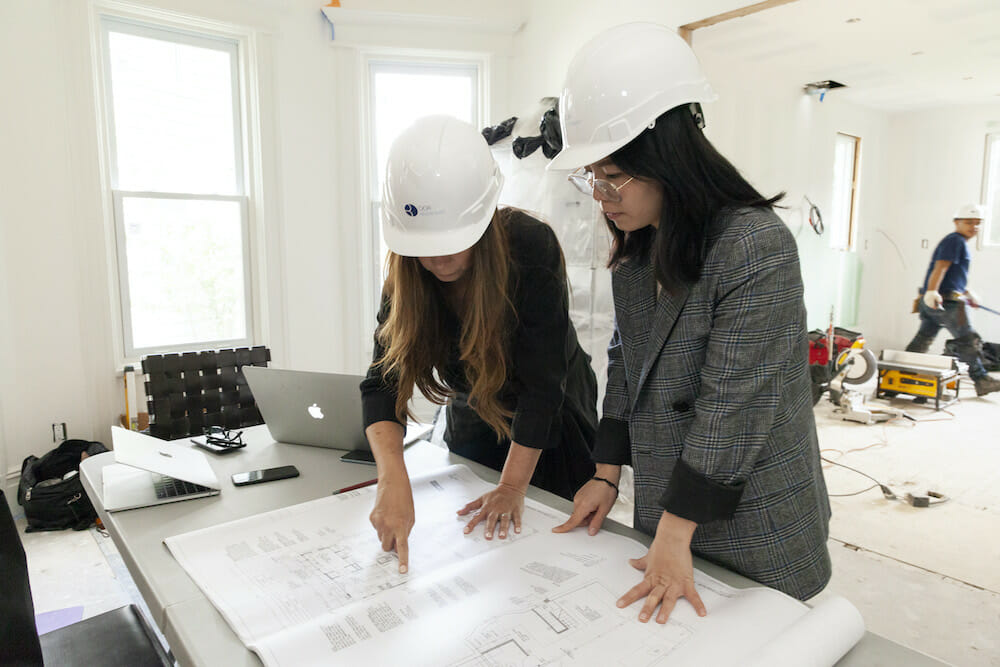 Image of two architects reviewing design plans