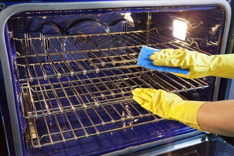 Oven, Major Household Appliance, Unrecognizable Person, Residential Structure, Chores, Photography, Washing Up Glove, Protective Glove, Domestic Life, Stainless Steel, Housework, Color Image, Cleaning, One Person, Shiny, Clean, Indoors, Horizontal, Close-up, Human Hand, People, Domestic Kitchen, Domestic Room, House, Home Interior, Stove, Appliance, Sponge, Kitchen