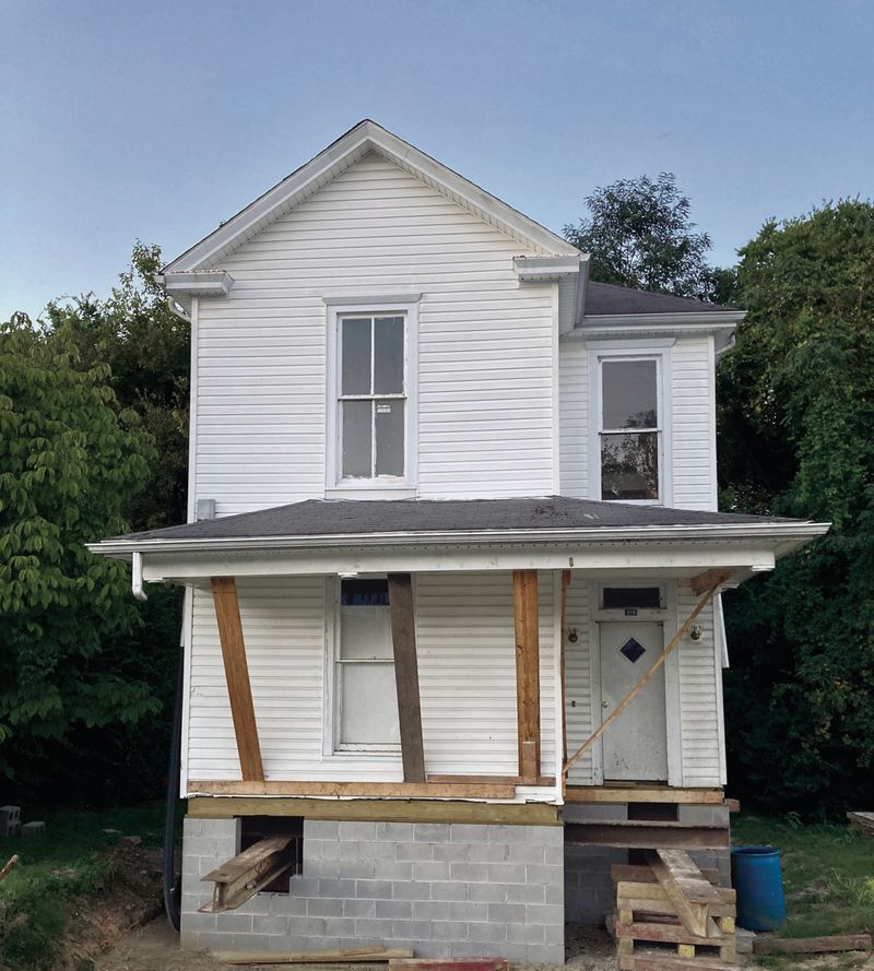  The three-bedroom, two-bath house still bears the I-beam supports that allowed it to be lifted and relocated via flatbed truck; these will be removed and the foundation made whole before the sale. The porch and chimney, removed for transport, will need to be rebuilt. Most of the remaining windows and trim are original 
