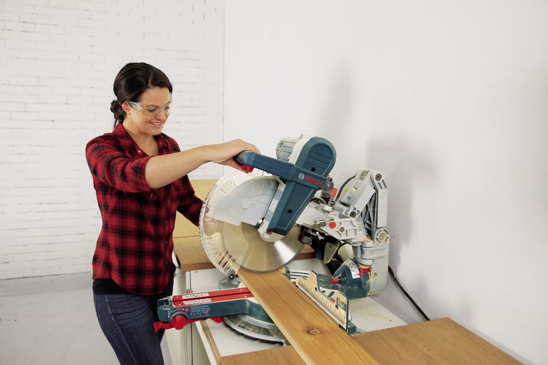 Jenn Largesse uses a miter saw to make wide cuts.