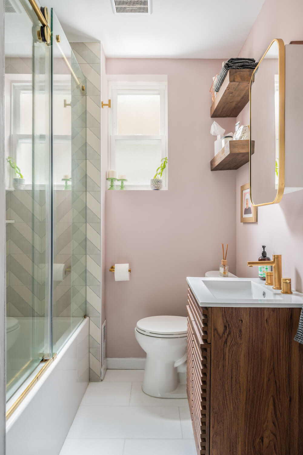 Bathroom with pink walls and wooden vanity