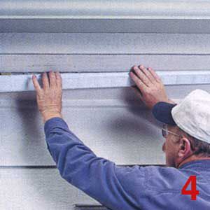 Person raising a vent to improve attic ventilation.